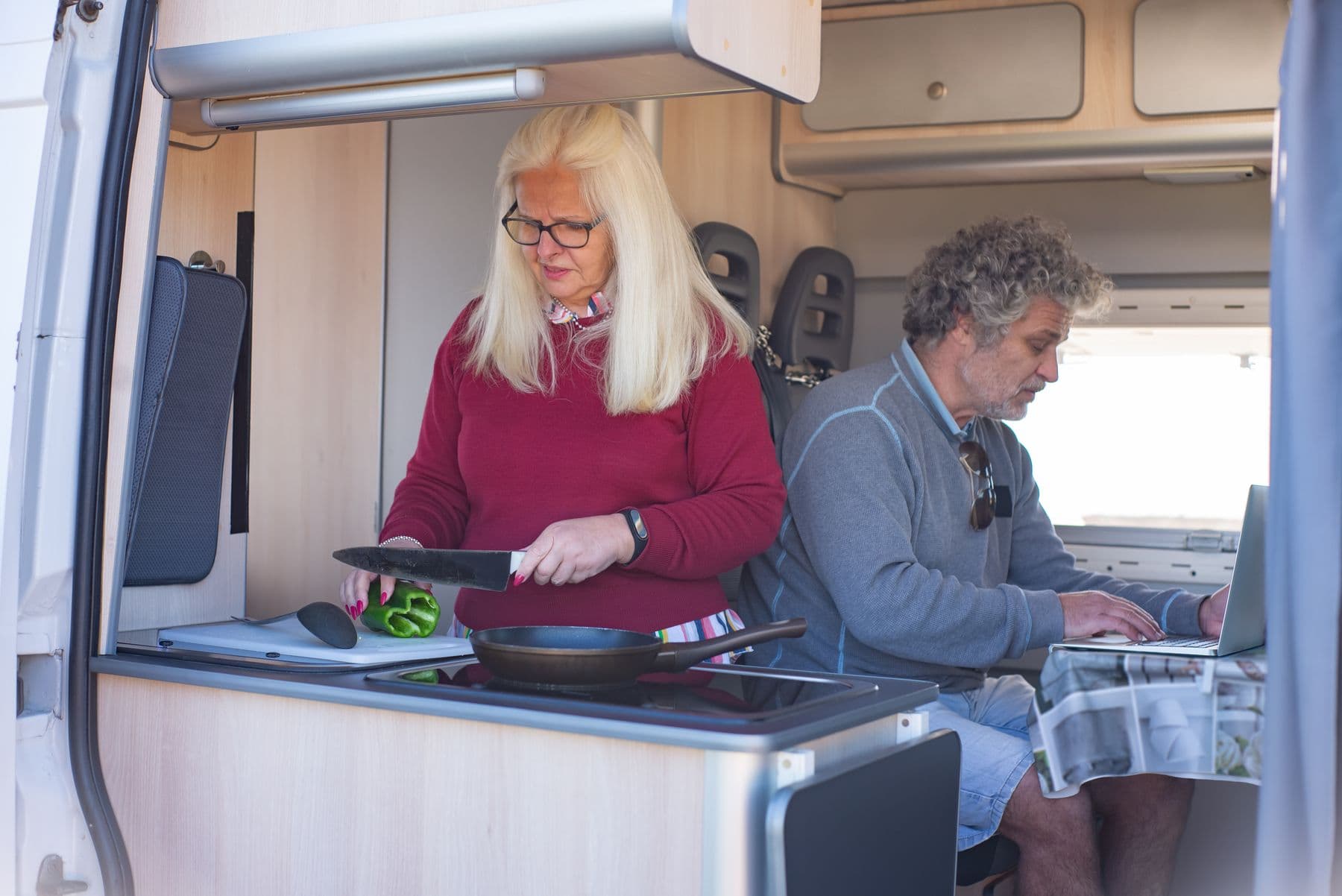 A couple using the internet together inside their parked RV